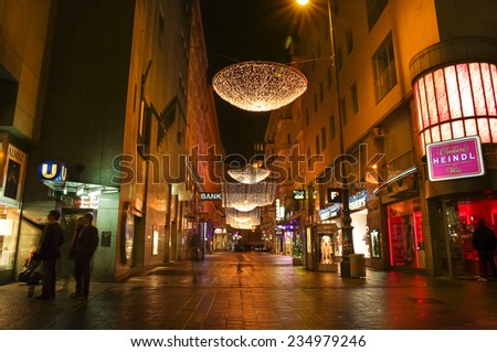 VIENNA, AUSTRIA - December 11, 2009: Vienna -  street at night with Christmas chandeliers in Vienna, Austria. on December 11, 2009