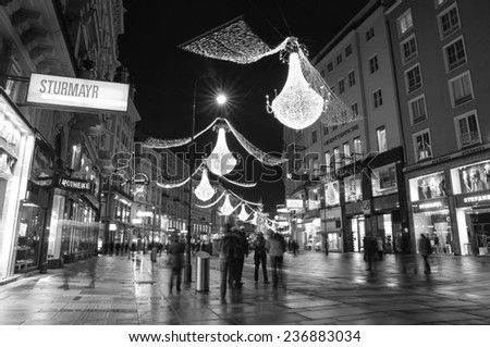 VIENNA, AUSTRIA - December 11, 2009: Vienna - tourists on famous Graben street at night with Christmas chandeliers in Vienna, Austria. on December 11, 2009.