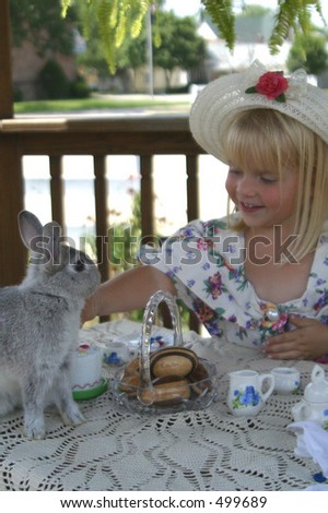 Tea party for young girl with bunny and stuffed animals