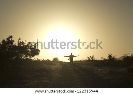 Man runs straight to the setting sun