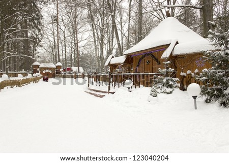 Snow-covered house in the beautiful winter forest