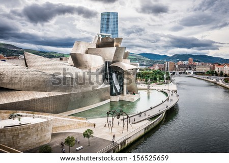 Bilbao, Spain - October 1: The Guggenheim Museum And Iberdrola Tower On October 1, 2013 In Bilbao, Spain. The Guggenheim Is A Museum Of Contemporary Art Designed By Architect Frank Gehry