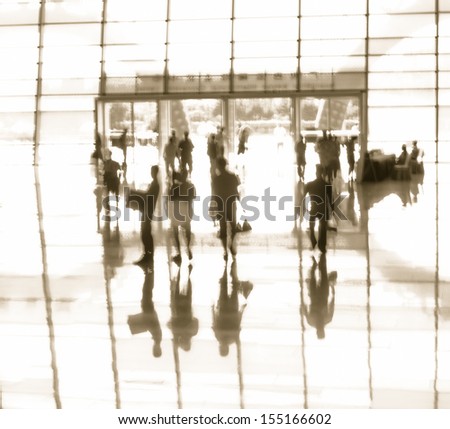 Business people activity standing and walking in the lobby motion blurred black and white