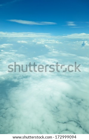 The view from the window of an airplane flying above the clouds. skyscape,blue sky with clouds.