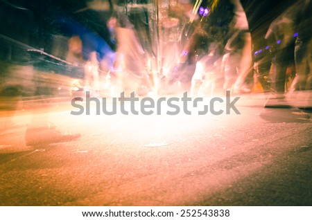 Abstract background-Legs of people in blurred motion with shadows on street.