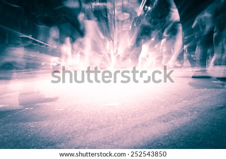 Abstract background-Legs of people in blurred motion with shadows on street.