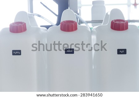 white chemical plastic barrels,lab background