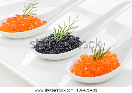 Red and black caviar on porcelain spoons