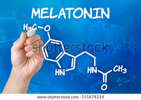Hand with pen drawing the chemical formula of melatonin Hand with pen drawing the chemical formula of melatonin