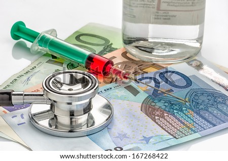 Stethoscope and syringe on bills