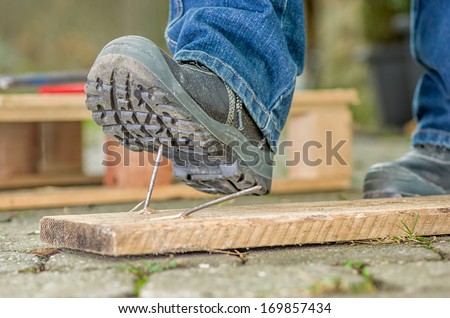 Worker With Safety Boots Steps On A Nail