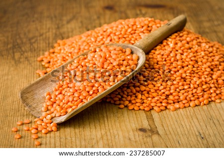 Wooden scoop with red lentils