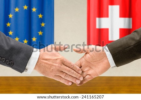 Representatives of the EU and Switzerland shake hands