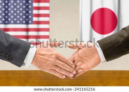 Representatives of the USA and Japan shake hands