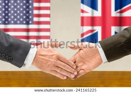 Representatives of the USA and the UK  shake hands