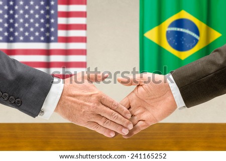 Representatives of the USA and Brazil shake hands