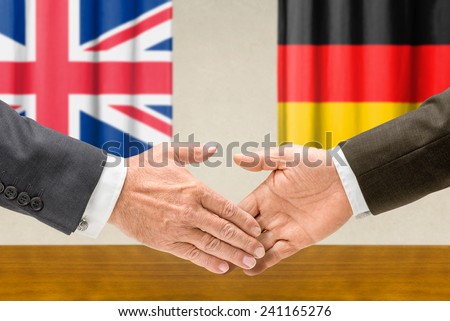 Representatives of the UK and Germany shake hands