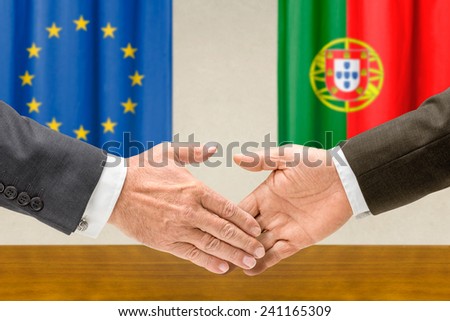 Representatives of the EU and Portugal shake hands
