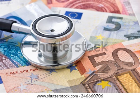 Close-up of a stethoscope on euro bills