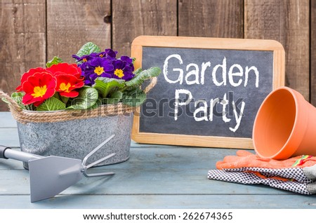 Blackboard on a plant table with the text Garden Party