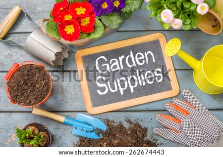 Blackboard on a plant table with garden tools - Garden Supplies