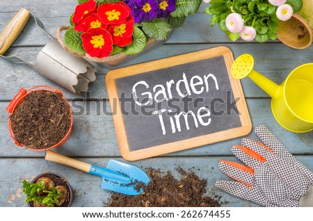 Blackboard on a plant table with garden tools - Garden Time