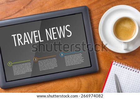 Tablet on a wooden desk - Travel News