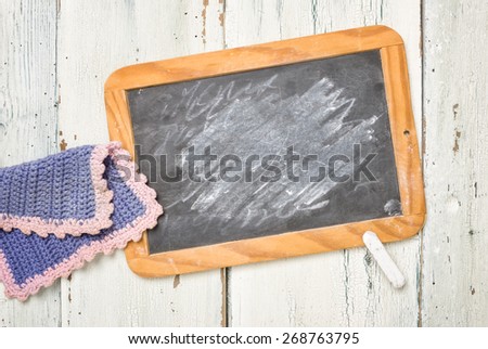Old school blackboard with chalk and a cleaning cloth
