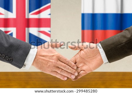Representatives of the UK and Russia shake hands
