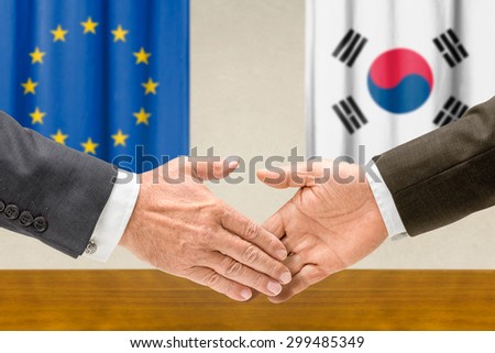 Representatives of the EU and South Korea shake hands