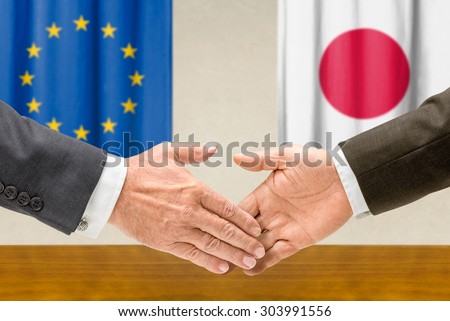Representatives of the EU and Japan shake hands