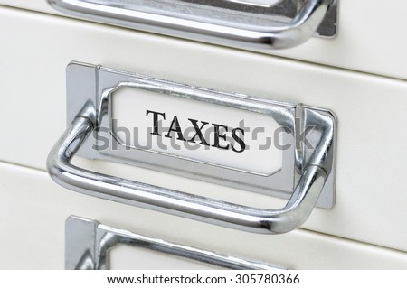 A drawer cabinet with the label Taxes