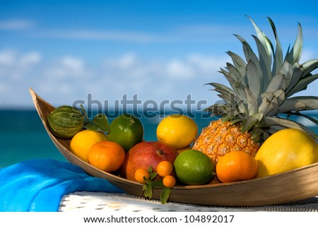 Basket of assorted tropical fruits, sea  on the background