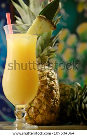 Glass of freshly squeezed pineapple juice and fresh pineapple