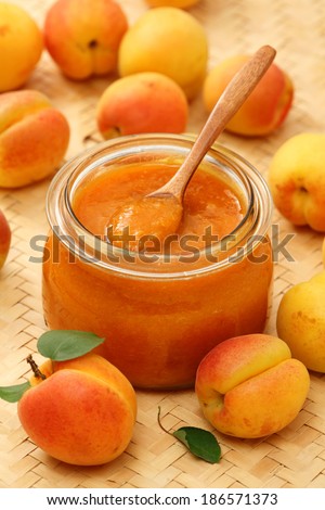 Apricot jam preserved in a jar  and  fresh apricots