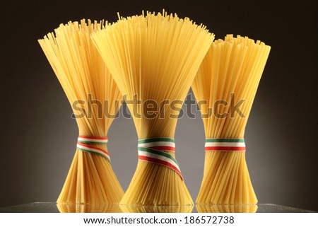 Spaghetti tied in a bunch with string  in colors of Italian flag