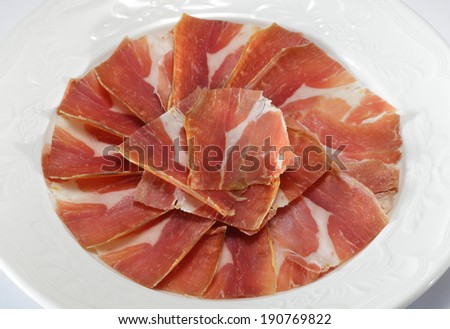Plate of Italian prosciutto/ Spanish hamon isolated on  white background