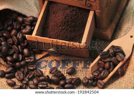 Coffee grinder, ground coffee and roasted coffee beans still life