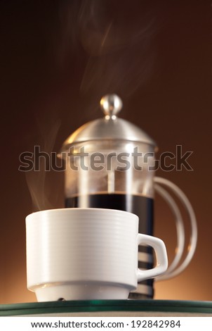 Espresso steaming coffee cup  and coffee maker/ French press