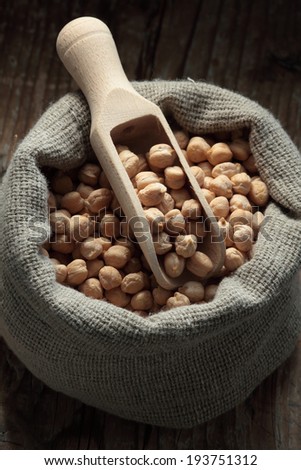 Chickpeas/ beans  in a sack with wooden scoop