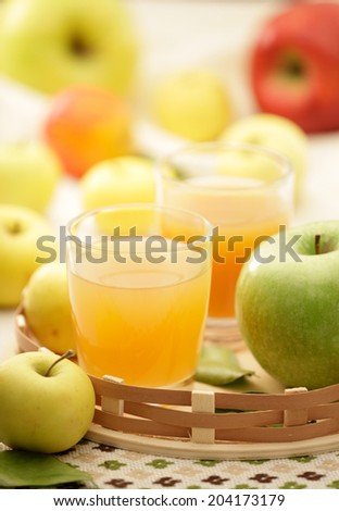 Apple juice and fresh green, red and yellow apples