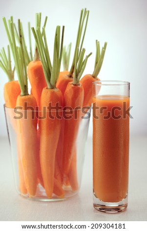 Glass of carrot juice and fresh carrots isolated on white  background