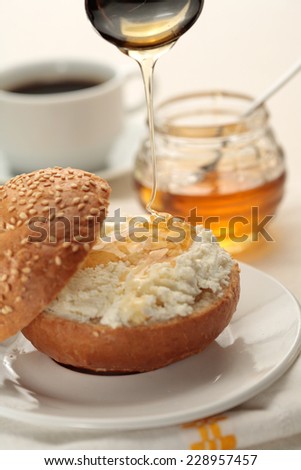Roll with cottage cheese and honey, coffee cup breakfast