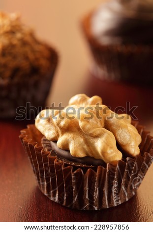 One chocolate candy isolated on brown background