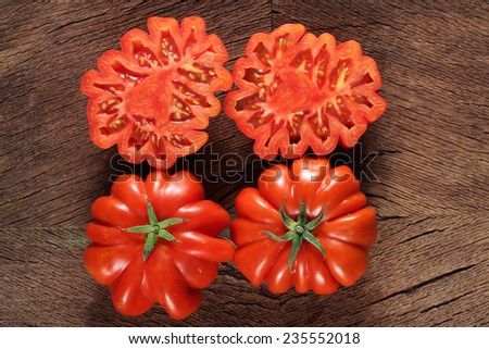Beefsteak tomatoes on wooden background
