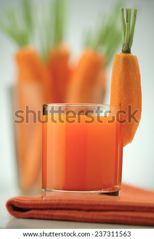 Carrot juice and fresh carrots isolated on white background