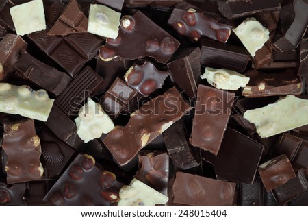 Mix of chocolate bar pieces made of dark chocolate, milk chocolate, white chocolate