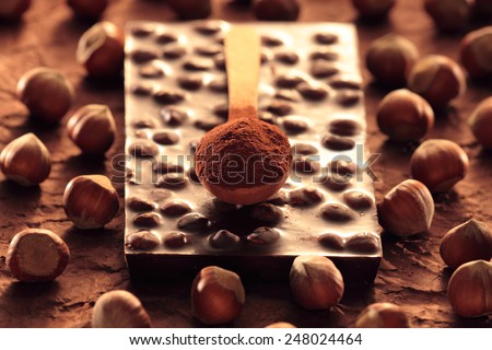 Nut chocolate bar surrounded by nuts
