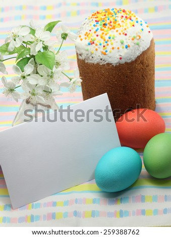 Painted Easter eggs, branch of flourishing cherry tree  and Easter bread still life