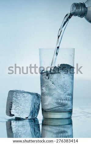 Glass of water with ice cubes isolated on white background